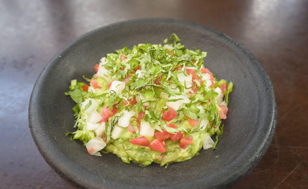 Large Guacamole · Made to order - fresh avocado, cilantro, lime, garlic confit, onion, tomato, and serrano chile. With chips cooked in rice oil. (vegetarian) (vegan)