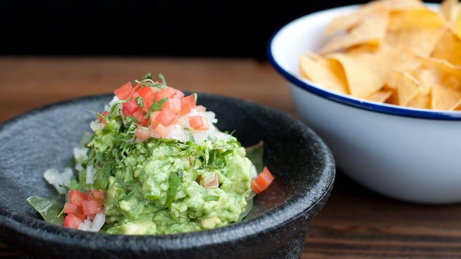 Small Guacamole · Made to order - fresh avocado, cilantro, lime, garlic confit, onion, tomato, and serrano chile. With chips cooked in rice oil. (vegetarian) (vegan)
