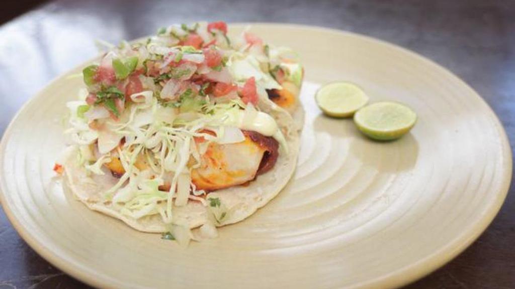 Baja Fish Tacos · Three Mahi Mahi tacos (your choice of grilled or fried), topped with cabbage, pico de gallo, aioli, and cilantro. Served with rice and beans. (contains gluten when fried)