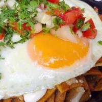Chilaquiles · House-made tortilla chips tossed in your choice of roasted tomato-jalapeno sauce, or tomatil...