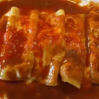 Enchiladas Rancheras · Two corn tortillas filled with chicken and topped with our customer favorite red enchilada s...