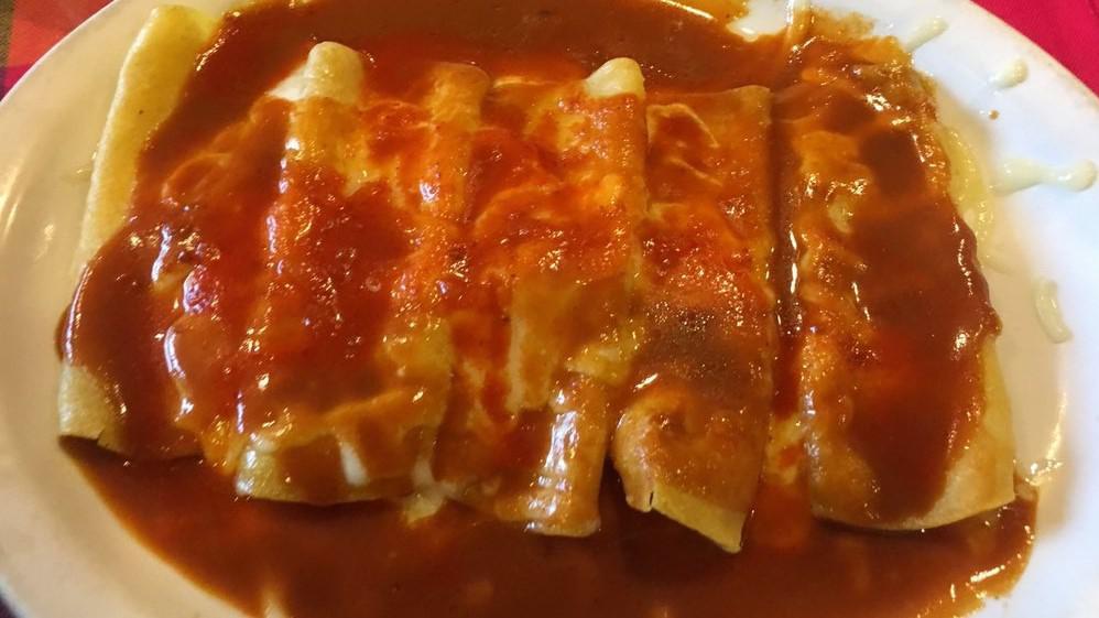 Enchiladas Rancheras · Two corn tortillas filled with chicken and topped with our customer favorite red enchilada sauce, melted cheese and two eggs cooked your way.