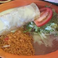 Carne Asada Burrito · Flour tortilla rolled and filled with skirt steak and beans topped with red burrito sauce an...