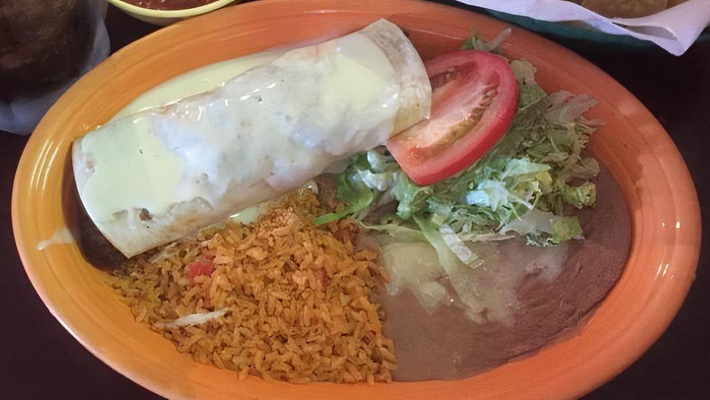Carne Asada Burrito · Flour tortilla rolled and filled with skirt steak and beans topped with red burrito sauce and melted cheese garnished with lettuce, pico de Gallo, sour cream, and guacamole. Served with rice and beans.