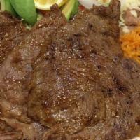 Carne Asada · Skirt steak cooked to your preference served with rice and beans garnished with lettuce, pic...