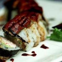 Baked Black Dragon · In: crabmeat, shrimp tempura, cucumber, avocado / out: eel, red and green tobiko, eel sauce.