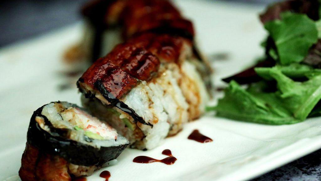 Baked Black Dragon · In: crabmeat, shrimp tempura, cucumber, avocado / out: eel, red and green tobiko, eel sauce.