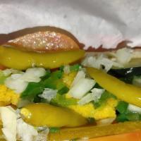 The Mother In Law · Tamale on a poppy seed bun topped with chili and your favorite hot dog toppings