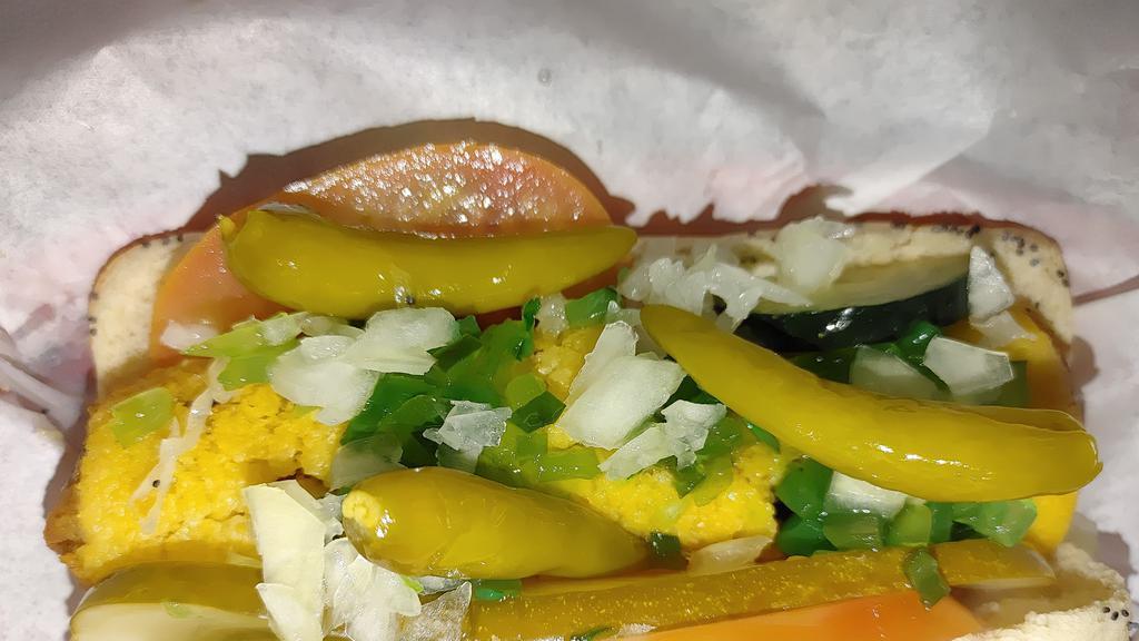 The Mother In Law · Tamale on a poppy seed bun topped with chili and your favorite hot dog toppings