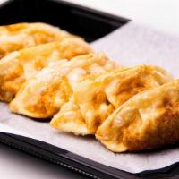 Gyoza · Fried pork dumplings with tempura sauce (6 pc)