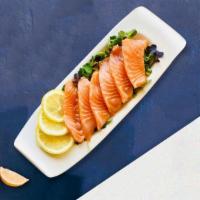 Sassy Salmon Sashimi · Slice of fresh salmon sashimi.
