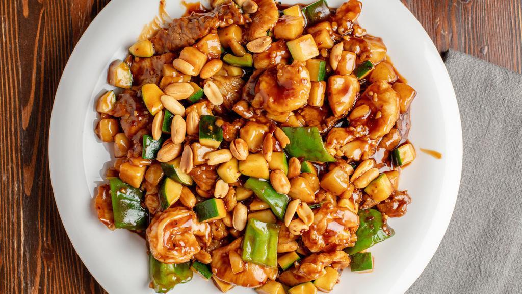 Kung Pao Chicken · Diced chicken stir-fried with green pepper, onion, zucchini, water chestnuts & roasted peanuts.