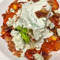 Wedge Salad · Iceberg wedge, bleu cheese crumbles, roasted Roma tomatoes, Nueske's bacon, homemade bleu ch...
