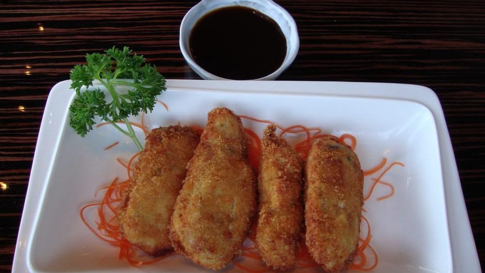 Golden Scallop Roll · Snow crab meat and avocado inside, deep fried, topped with baked creamy scallops and masago.