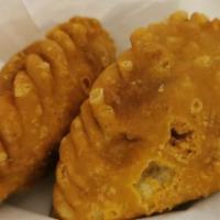 Curry Puff · Small pie consisting of specialized curry with potatoes in a deep-fried served with cucumber...