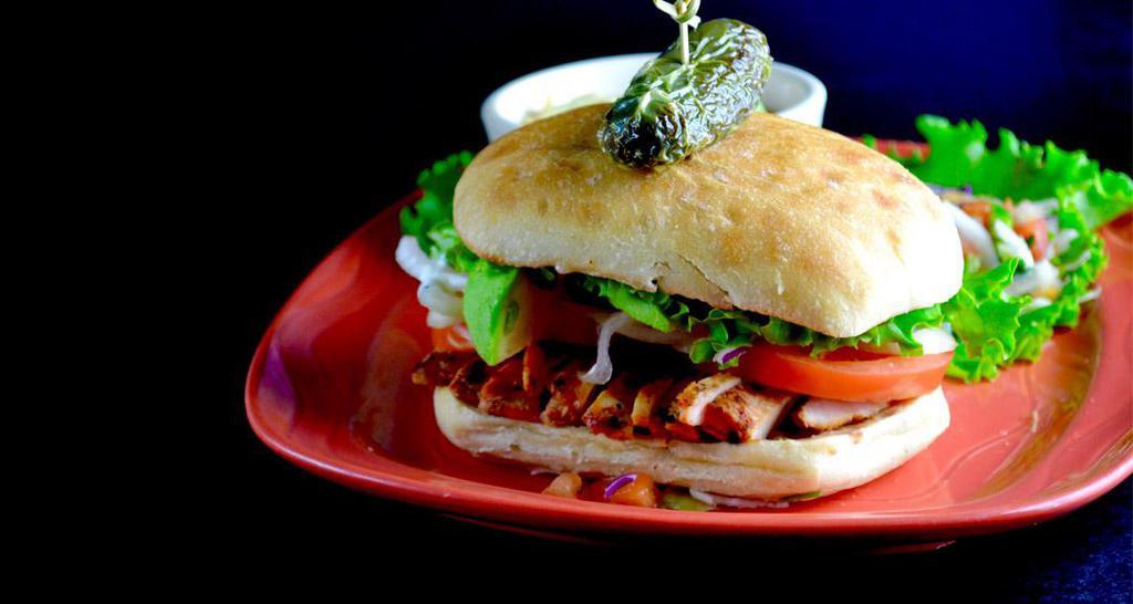 Chicken Sandwich · 6 oz. Boneless, skinless, charbroiled adobo chicken breast served with green leaf lettuce, tomato and onion. Served with Azteca fries.