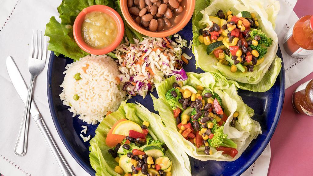 Vegan Lettuce Wraps · Gluten free. Iceberg lettuce halves filled with roasted vegetables, roasted corn and black bean salsa, served with black beans, white rice and our homemade tomatillo salsa.