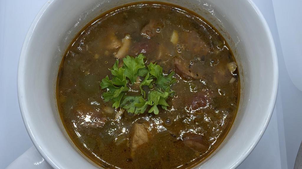 Chicken & Andouille Sausage Gumbo · Gumbo made from scratch with chicken, andouille sausage in a dark roux with fresh onions and peppers, seasoned with our house made seasoning. Served with rice.