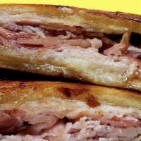  Medianoche · HOT PRESSED Sweet bread , Honey Ham, Pork Loin, Swiss Cheese, Mustard and Pickles