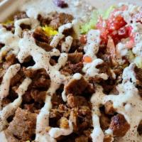 Gyro Plate · Traditional lamb and beef gyro cooked with onion over basmati rice. Served with warm pita br...