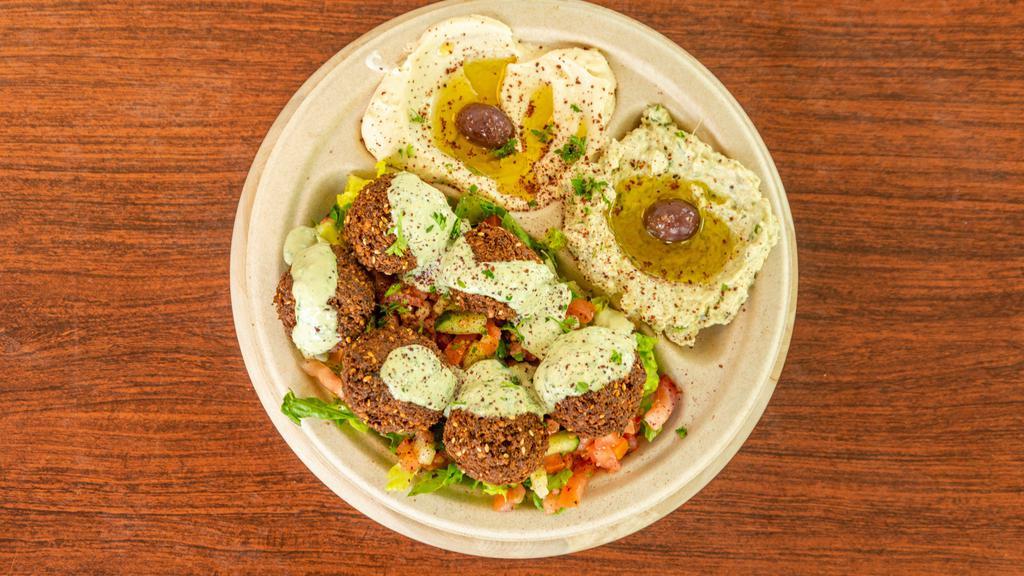 Mixed Vegetable Plate · Vegan. Falafels over salad, topped with tahini sauce. Served with hummus, Baba ghanouj, and warm pita bread.