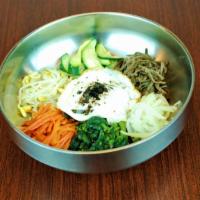 Bibimbap · Seasoned vegetables, beef and an egg with rice.