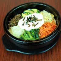 Namul Dolsot Bibimbap · Seasoned vegetables, beef, and an egg over rice in a hot stone pot.