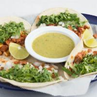 Tacos Al Pastor · Soft warm corn tortilla filled with marinated chopped pork loin with diced pineapple, fresh ...