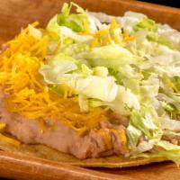 Bean Tostada · Refried beans, grilled pork, cheese, and lettuce.