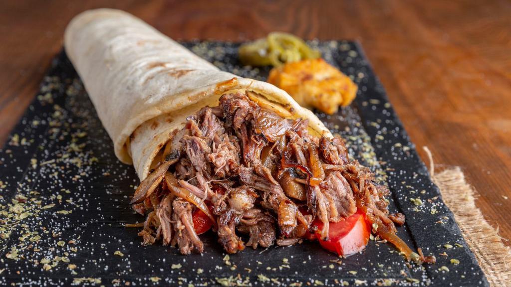 Machaca Breakfast Burrito · Shredded beef, eggs, bell peppers, onions, and tomato wrapped in a large warm flour tortilla.