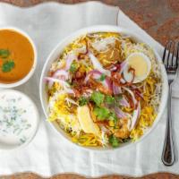 Chicken Dum Biryani · Containing tender marinated meat or vegetables flavored with exotic spices cooked with basma...