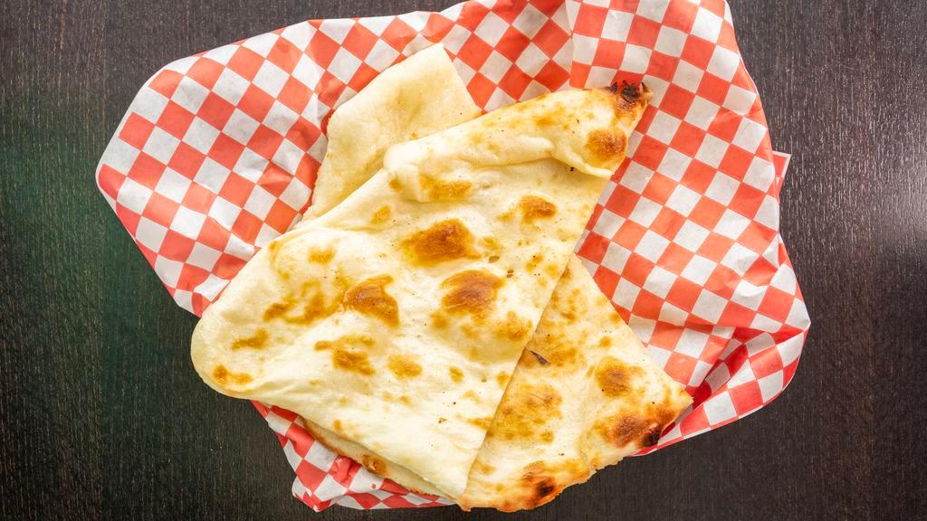 Butter Naan · Traditional Indian bread baked in a clay oven topped with butter.