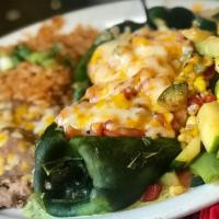 Shrimp Stuffed Poblano Chiles · Two chiles stuffed with shrimp in a blend of Monterey Jack cheese, onions and tomatoes. Serv...