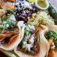 Traditional Mexican Taco Platter · Choice of protein, cilantro, chopped onion, tomatillo verde sauce. Served with two corn tort...