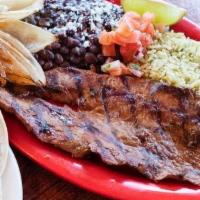 Carne Asada Platter · Marinated and grilled skirt steak. Served with a blistered onion and a side of fried jalepeñ...