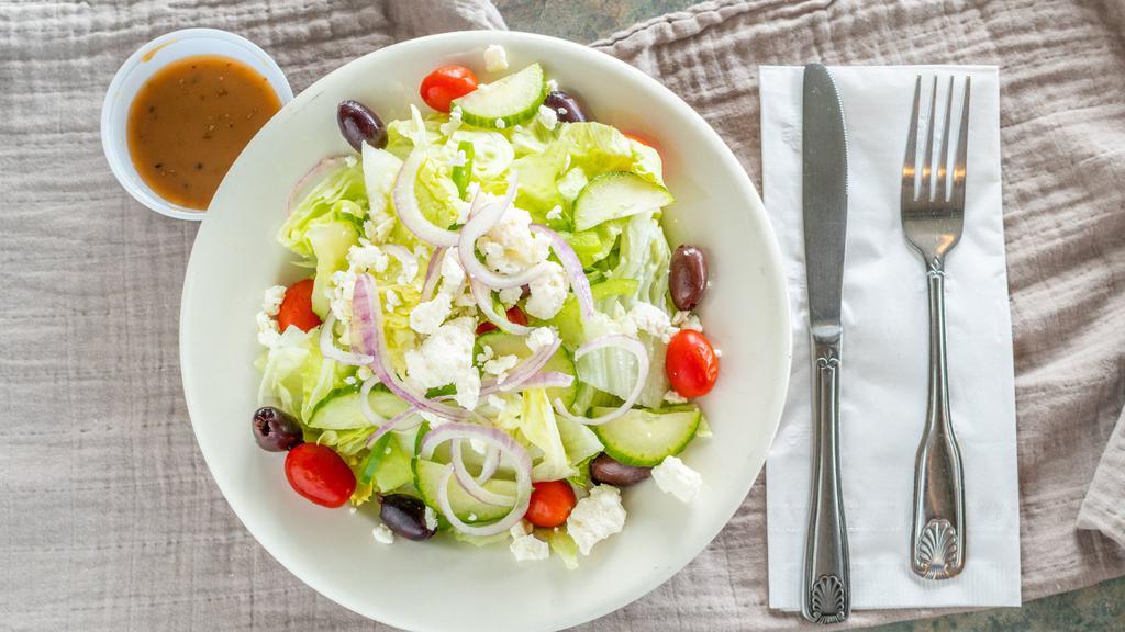 Italian Salad · Freshly chopped iceberg lettuce, grape tomato halves, Kalamata olives, julienne of green pepper, sliced red  onion, crumbled feta cheese and served with a home made balsamic vinaigrette on the side.