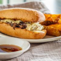 Swiss French Dip · Thinly sliced roast beef, white onions, Swiss cheese and garlic butter on French bread, serv...