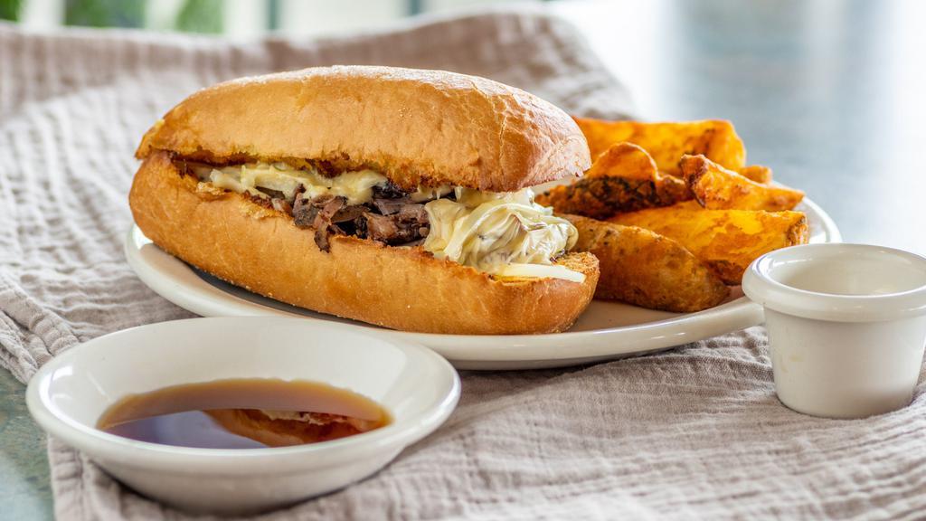 Swiss French Dip · Thinly sliced roast beef, white onions, Swiss cheese and garlic butter on French bread, served with au jus.