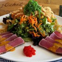 Seared Ahi Salad · Five spice rubbed Ahi tuna seared rare, mixed greens, cucumber, carrots, wonton strips, waka...