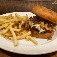 Bbq Pulled Pork Sandwich · Smoked pork shoulder, BBQ sauce, crispy onions, and coleslaw. Served with your choice of side.