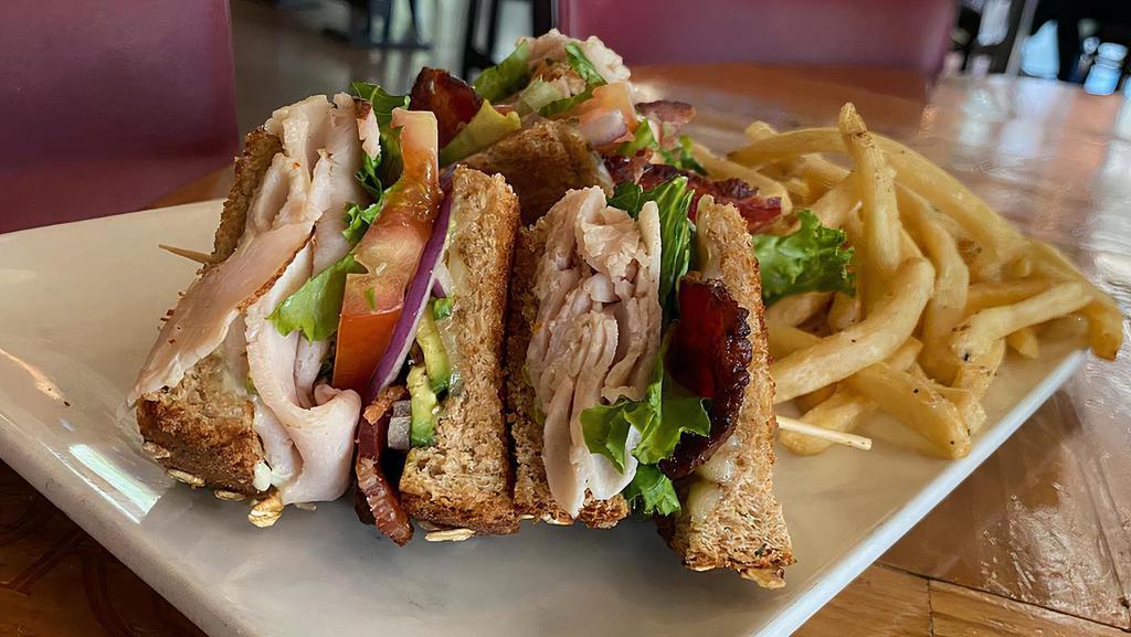 Turkey Club · Shaved turkey breast, applewood smoked bacon, leaf lettuce, tomato, onion, pepper jack cheese, roasted jalapeno cream cheese spread, toasted honey wheat bread