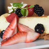 Ny Style Cheesecake · Traditional cheesecake with fresh berries and whipped cream.