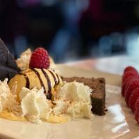Flourless Chocolate Torte · Dark chocolate torte with raspberry coulis and whipped cream.