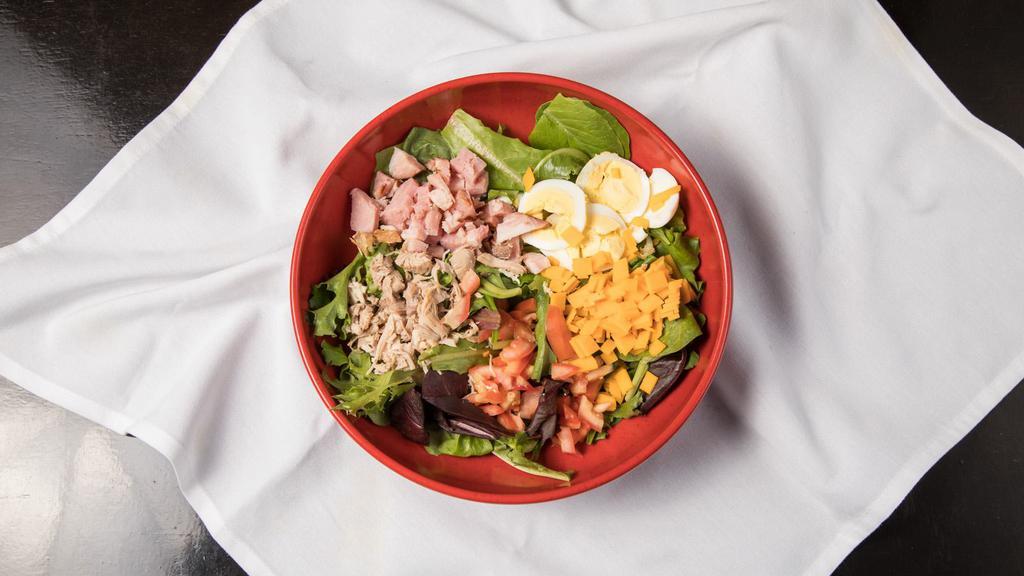 Chef Salad · Ham, Turkey, Lettuce Mix, Cheddar Cheese, Diced Eggs, Tomatoes & Field Greens.