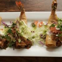 Shrimp Taquitos · Jumbo Mexican shrimp stuffed with a creamy dungeness crab filling wrapped with crispy corn t...