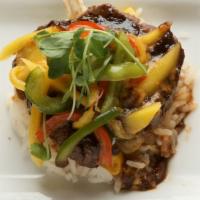 Sugar Cane Filet · Tenderloin medallions marinated with orange chipotle sauce served over white rice, topped wi...