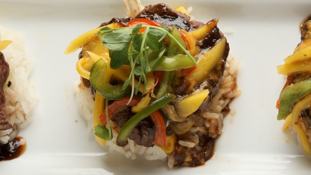 Sugar Cane Filet · Tenderloin medallions marinated with orange chipotle sauce served over white rice, topped with mango and tamarindo glaze.