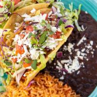 2 Crispy Tinga Chicken Taocs · lettuce-cabbage, cheese, pico, queso
served with rice and beans