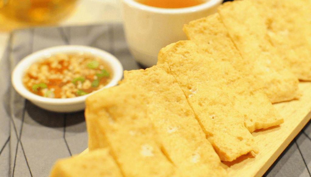 Thai Tofu · Crispy fried tofu. Served with sweet and sour sauce and crushed peanuts.