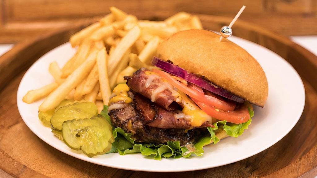 Turkey Bacon Burger Meal · 6 Oz. Charbroiled Seasoned Angus Ground Chuck Burger. Topped with Thick Cut Turkey Bacon, Your Choice of Cheese with Lettuce, Tomato, Onions & House Sauce.  Served w/ a Side of French Fries.